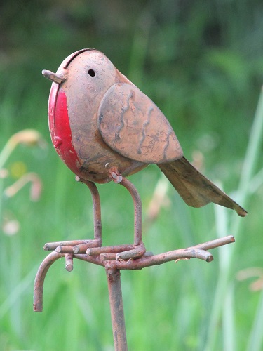 A metal sculpture of a robin with painted red breast