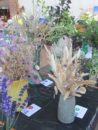 A vase of dry grasses and seed heads