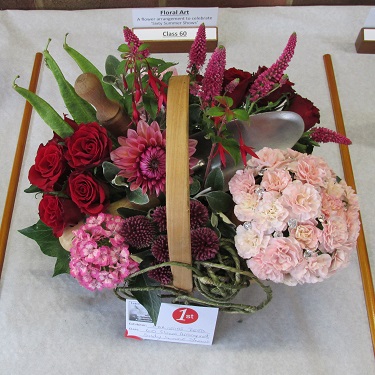 A flower arrangement of pinks, reds and purples